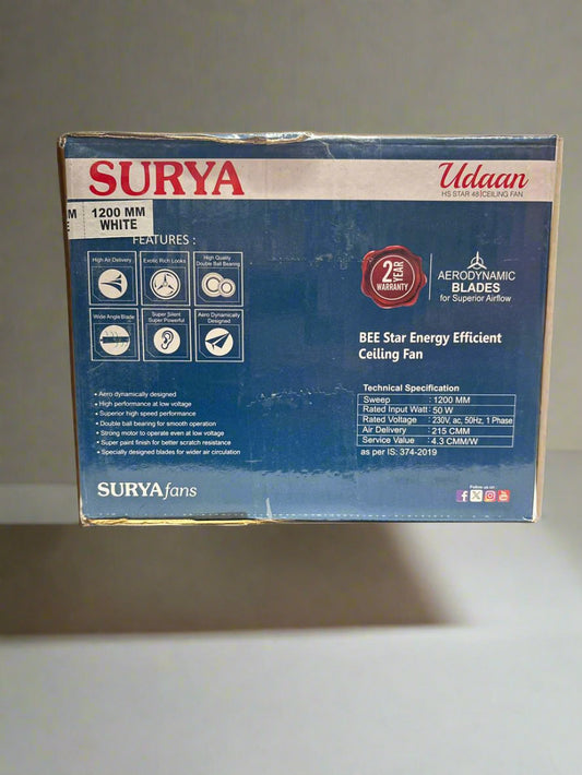Surya ceiling fan box on a white surface with a blurred background